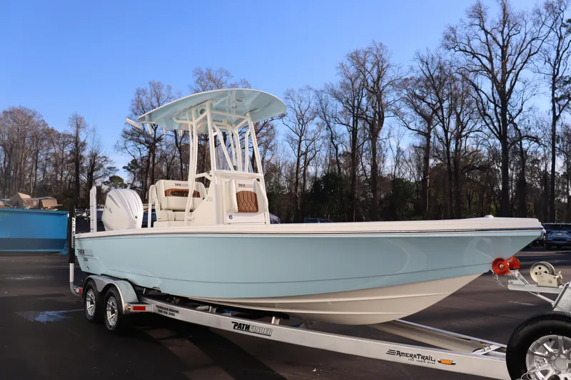 Slide: The Image of 2024 Pathfinder 2500 Hybrid boat on trailer in outdoor setting. - 8