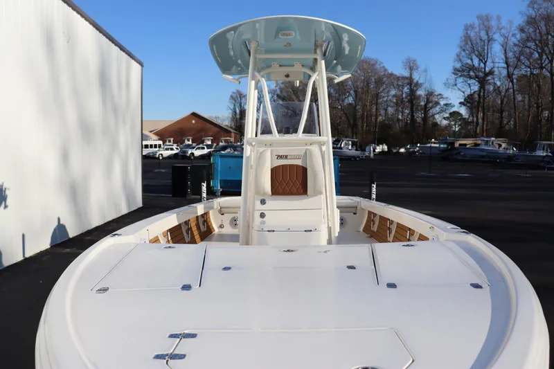 Slide: The Image of 2024 Pathfinder 2500 Hybrid boat with center console and T-top in a marina. - 9