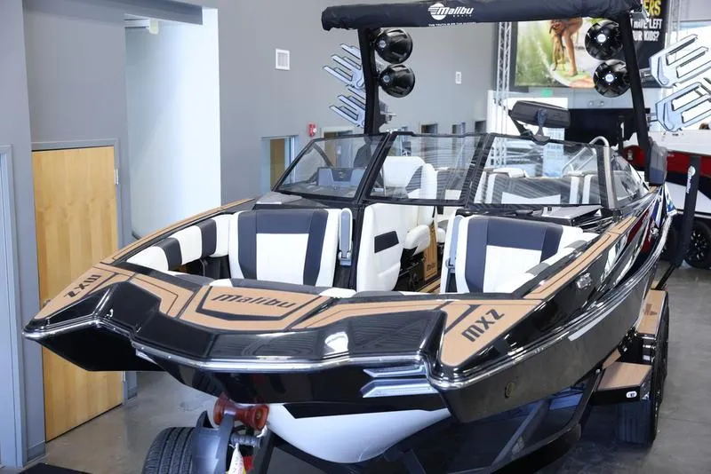 Slide: The Image of 2024 Malibu 24 MXZ boat on display in showroom. - 10