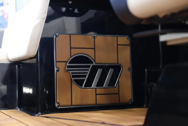 Slide: The Image of 2024 Malibu 24 MXZ interior detail with custom speaker grille and wood paneling. - 14