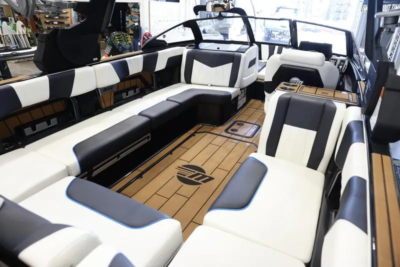 Slide: The Image of 2024 Malibu 24 MXZ boat interior with luxurious seating and modern design. - 16
