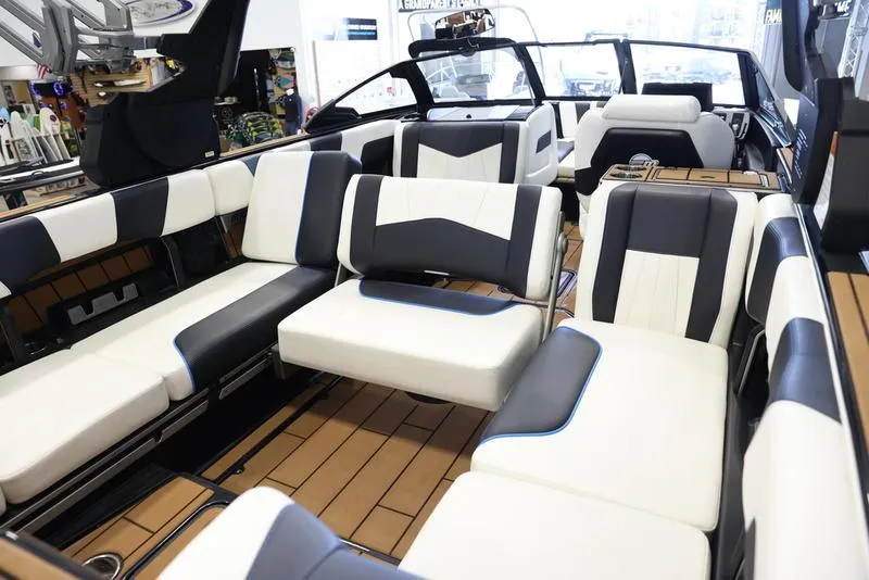 Slide: The Image of 2024 Malibu 24 MXZ boat interior with luxurious seating and modern design. - 18