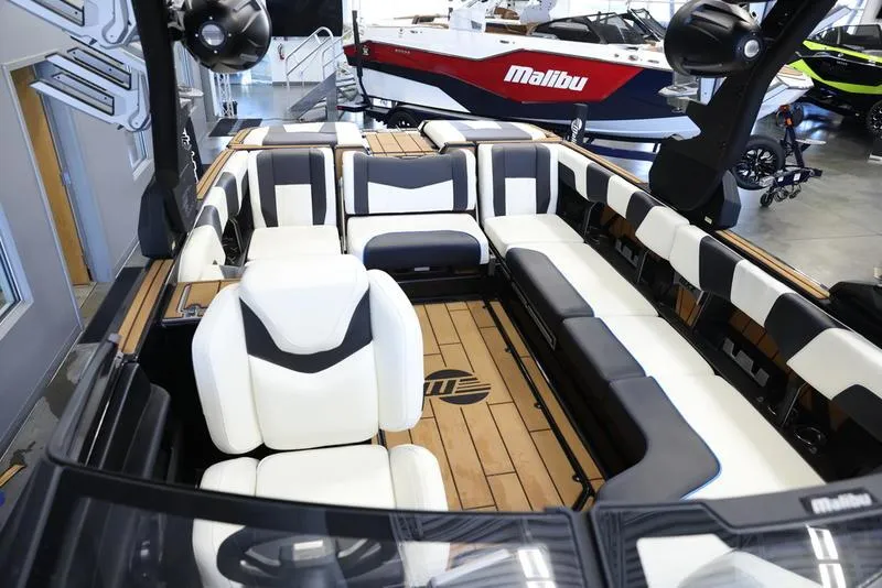 Slide: The Image of 2024 Malibu 24 MXZ boat interior with luxurious seating and modern design. - 19