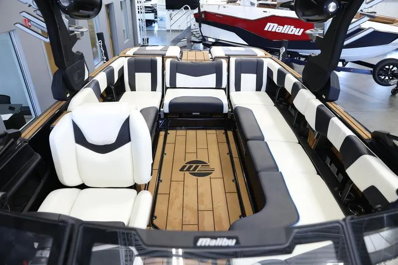 Slide: The Image of 2024 Malibu 24 MXZ boat interior with white and black seating. - 22