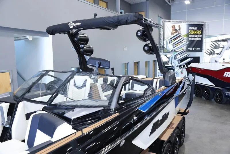 Slide: The Image of 2024 Malibu 24 MXZ boat with sleek design and modern features in showroom. - 8