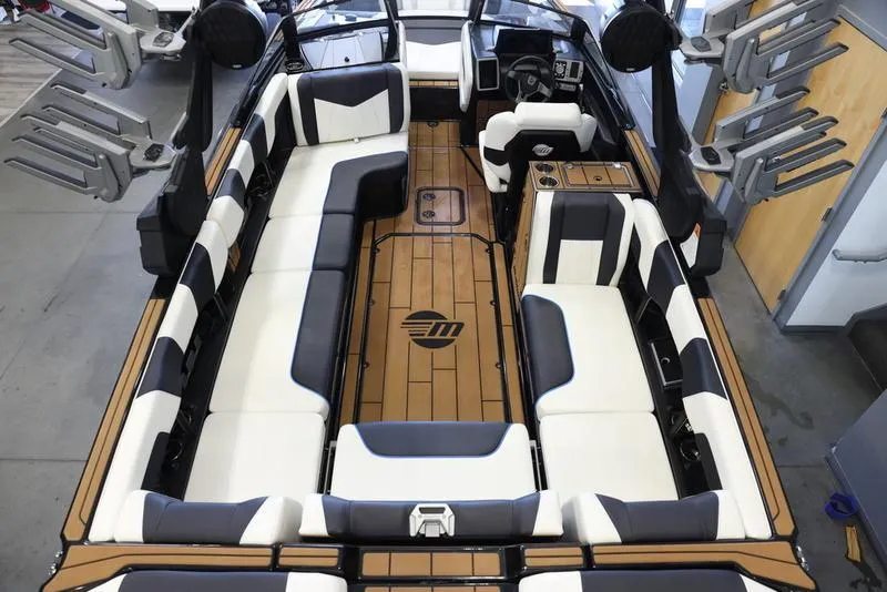 Slide: The Image of 2024 Malibu 24 MXZ boat interior with spacious seating and modern design. - 9