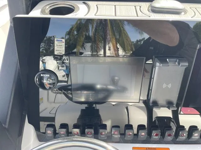 Slide: The Image of 2024 Yamaha Boats 252SD interior view with tan seating and modern dashboard. - 10