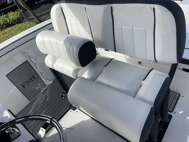 Slide: The Image of 2024 Yamaha Boats 252SD bow seating area with tan upholstery. - 12