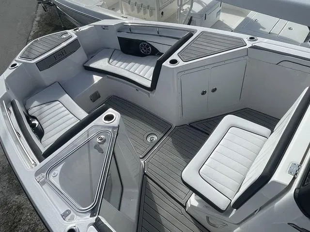 Slide: The Image of 2024 Yamaha Boats 252SD interior seating area with tan cushions and white deck. - 14