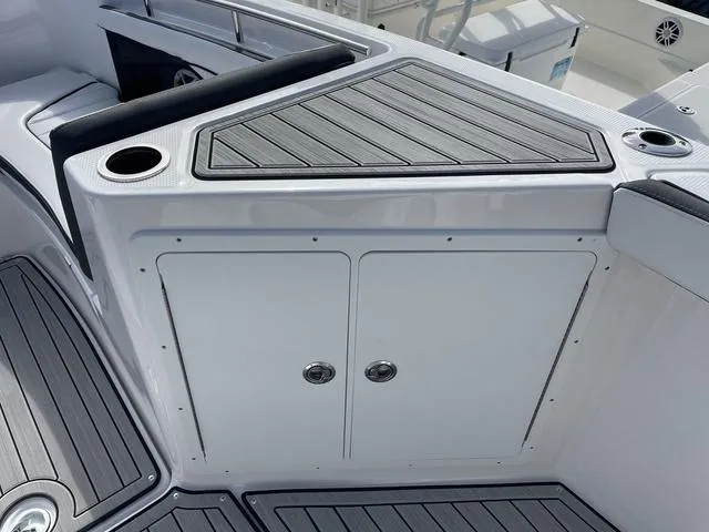 Slide: The Image of 2024 Yamaha Boats 255 FSH Sport H deck with storage and cup holders. - 17