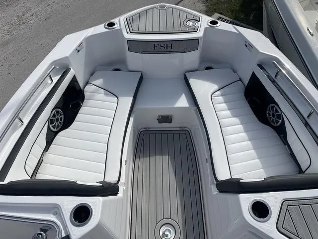 Slide: The Image of 2024 Yamaha Boats 255 FSH Sport H interior with white seating and modern design. - 18