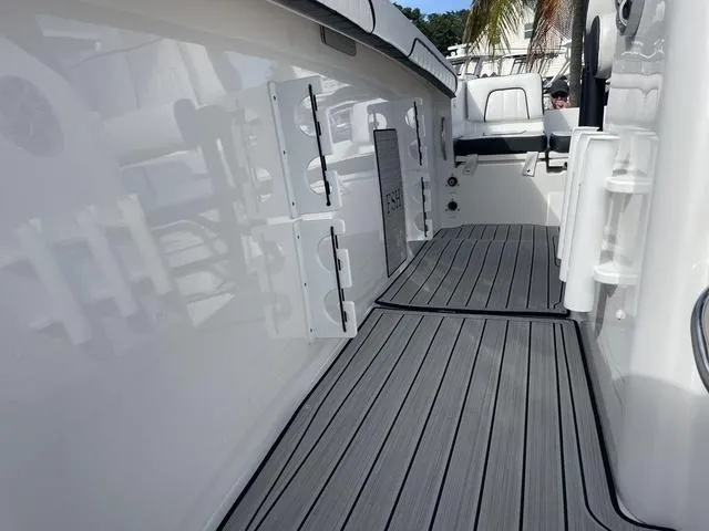 Slide: The Image of 2024 Yamaha Boats 255 FSH Sport H interior with sleek deck and rod holders. - 23