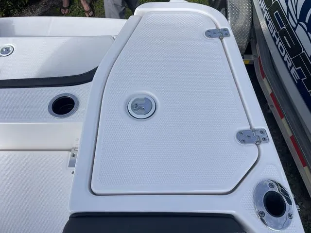 Slide: The Image of 2024 Yamaha Boats 255 FSH Sport H deck with storage compartment and cup holders. - 28