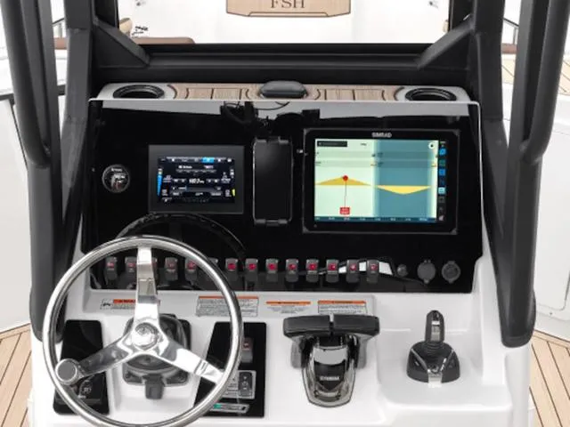 Slide: The Image of 2024 Yamaha Boats 255 FSH Sport H dashboard with steering wheel and navigation screens. - 34