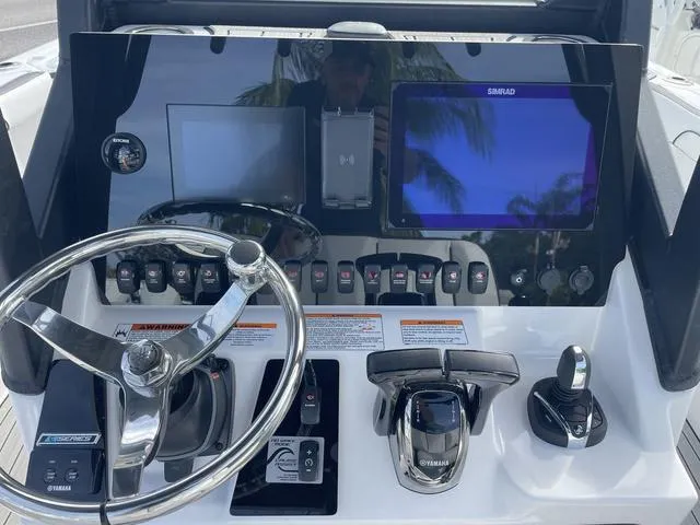 Slide: The Image of 2024 Yamaha Boats 252SD interior with brown seating and white deck. - 7