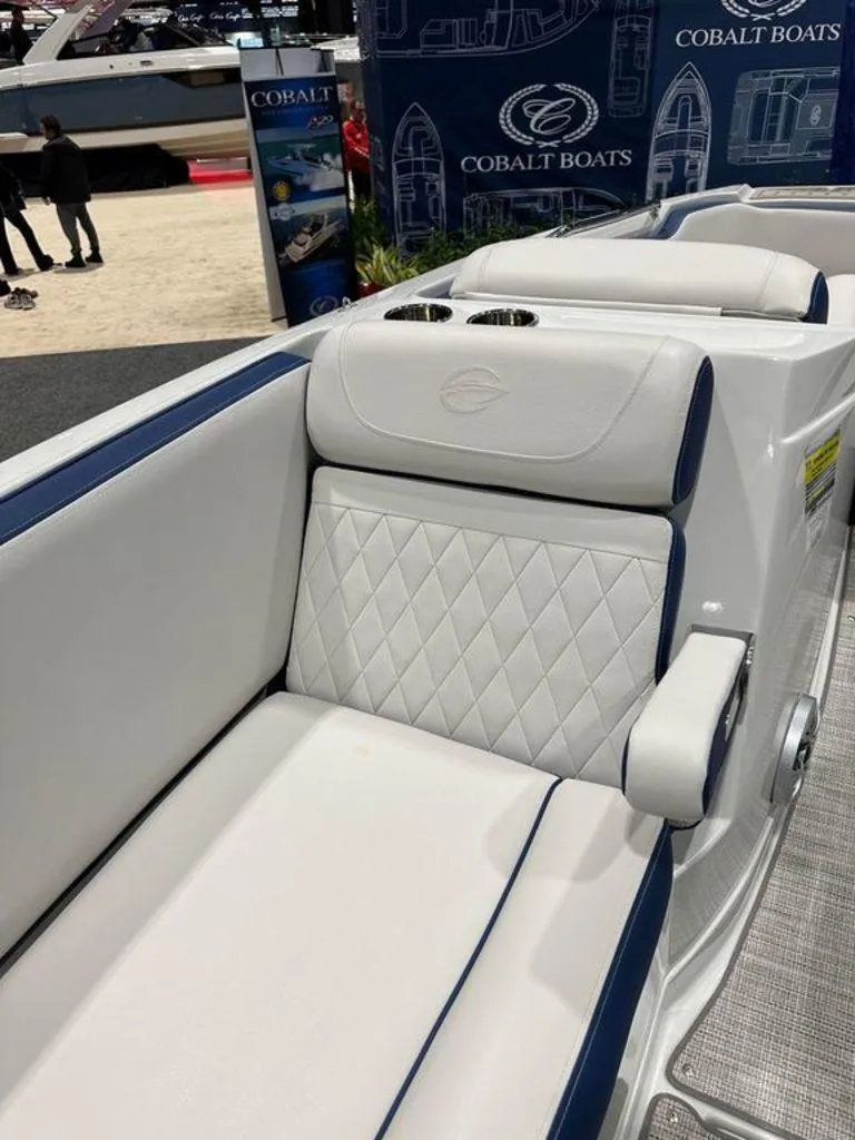 Slide: The Image of 2024 Crownline E230 XS boat interior with white and blue seating. - 5