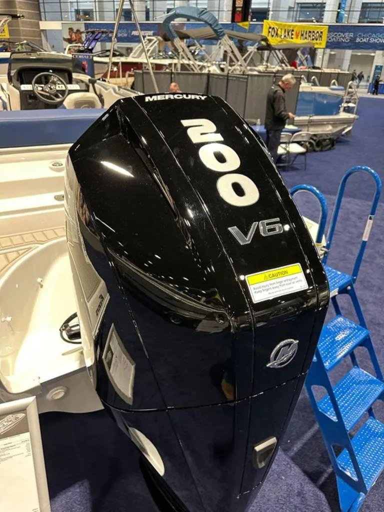 Slide: The Image of 2024 Crownline E230 XS with Mercury 200 V6 outboard engine at a boat show. - 8