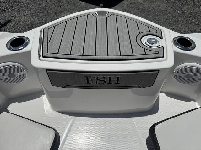 Slide: The Image of 2024 Yamaha Boats 222 FSH Sport storage compartment with open hatch, showcasing interior design. - 13
