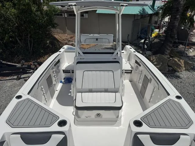 Slide: The Image of 2024 Yamaha Boats 222 FSH Sport interior, featuring seating and storage compartments. - 15