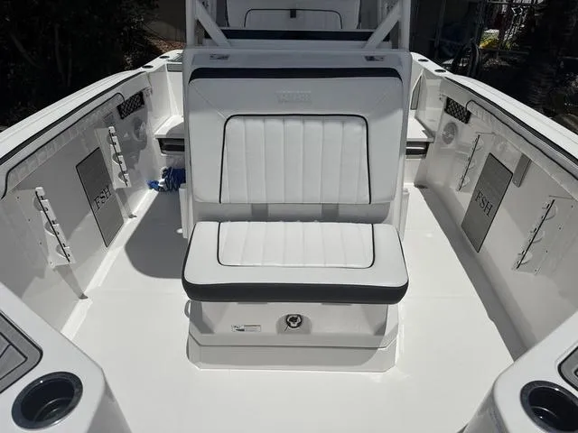 Slide: The Image of 2024 Yamaha Boats 222 FSH Sport interior with white seating and fishing compartments. - 16