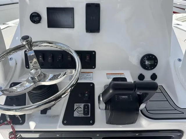 Slide: The Image of 2024 Yamaha Boats 222 FSH Sport dashboard with steering wheel and controls. - 18