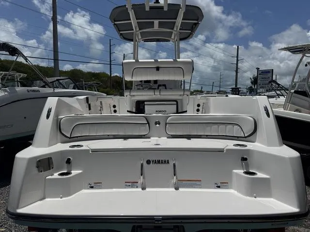 Slide: The Image of 2024 Yamaha Boats 222 FSH Sport E interior with seating and helm. - 3