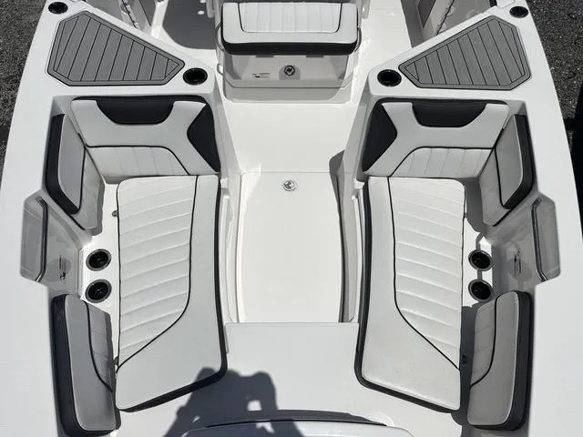 Slide: The Image of 2024 Yamaha Boats 222 FSH Sport interior seating, featuring sleek white and gray upholstery. - 32