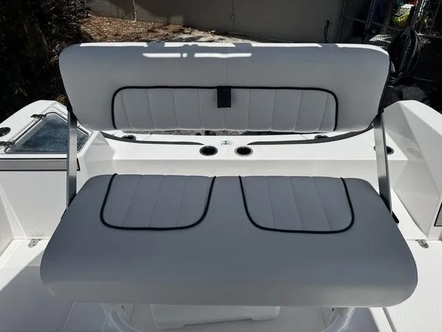 Slide: The Image of 2024 Yamaha Boats 222 FSH Sport white cushioned seating, sleek design, and modern features. - 38