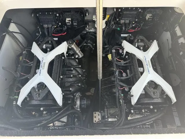 Slide: The Image of 2024 Yamaha Boats 222 FSH Sport engine compartment with dual engines and wiring. - 40