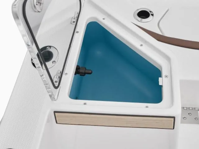 Slide: The Image of 2024 Yamaha Boats 222 FSH Sport storage compartment with open lid, showcasing interior design. - 48