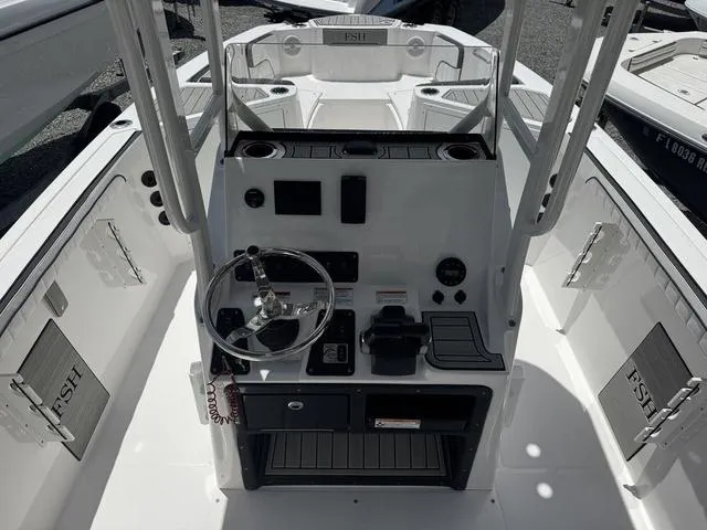 Slide: The Image of 2024 Yamaha Boats 222 FSH Sport E storage compartment with open hatch. - 6