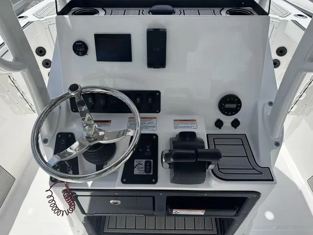 Slide: The Image of 2024 Yamaha Boats 222 FSH Sport E dashboard with controls and steering wheel. - 7