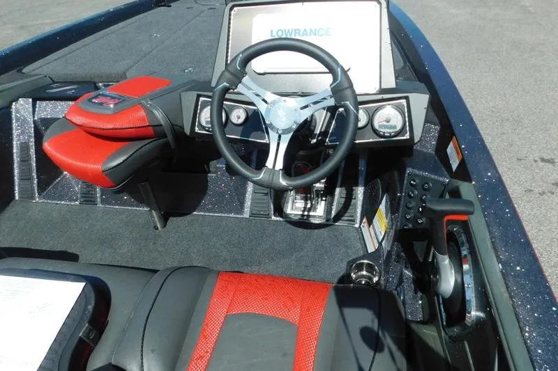 Slide: The Image of 2024 Ranger Z519 boat cockpit with steering wheel, Lowrance display, and red-black seating. - 10