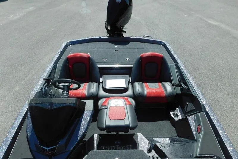Slide: The Image of 2024 Ranger Z519 boat interior with red and black seating, steering wheel, and dashboard. - 15