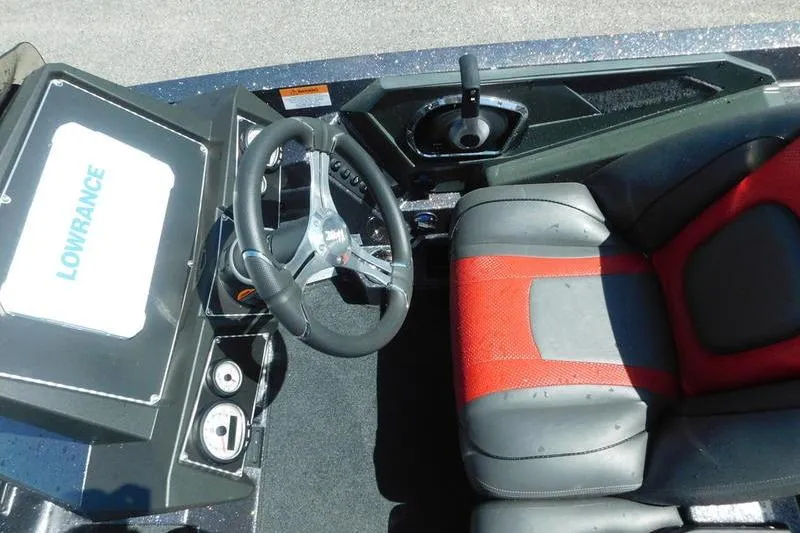 Slide: The Image of 2024 Ranger Z519 boat interior with steering wheel and red-accented seat. - 9