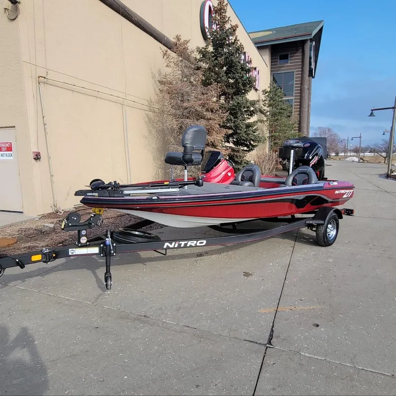 Slide: The Image of 2024 Nitro Z17 boat in red and black, parked on a trailer outside a building. - 4