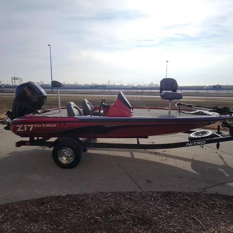 Slide: The Image of 2024 Nitro Z17 fishing boat on trailer, red and black design, side view. - 7