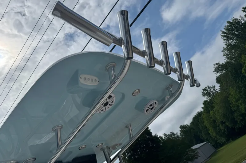 Slide: The Image of 2026 Bulls Bay 230 CC boat, rear view, featuring outboard motor and blue hull. - 4