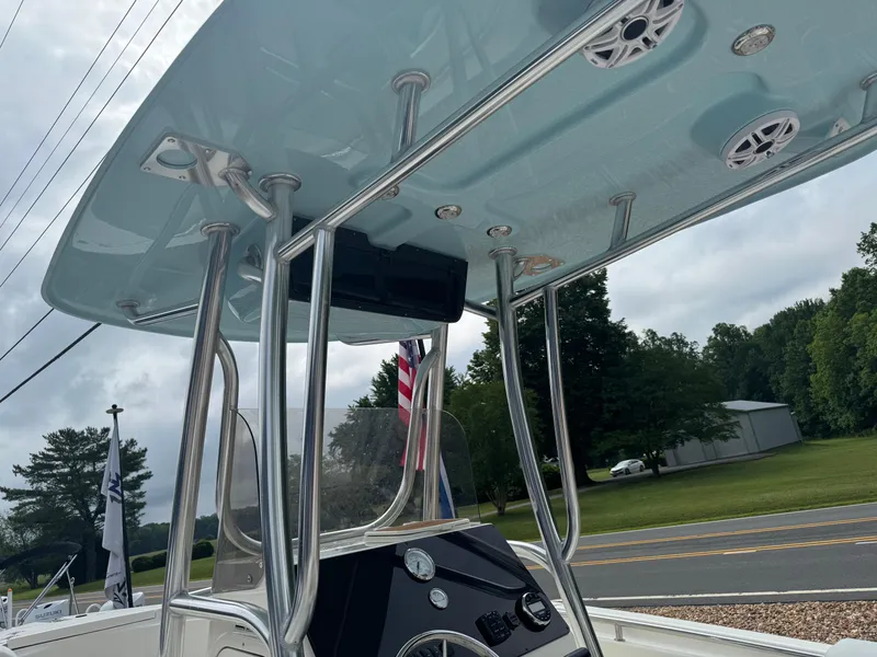 Slide: The Image of 2026 Bulls Bay 230 CC boat interior seating with Suzuki engine in background. - 6