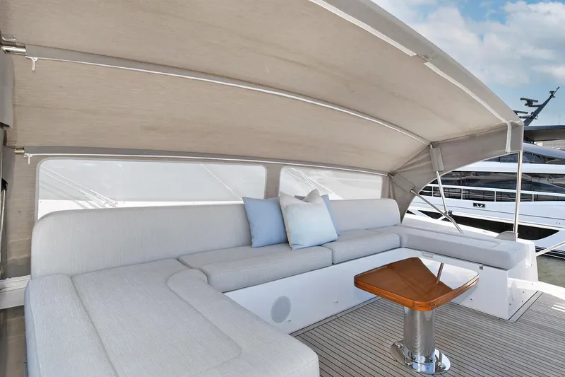 Slide: The Image of Luxurious seating area on the 2022 Azimut 72 FLY yacht with a wooden table. - 19