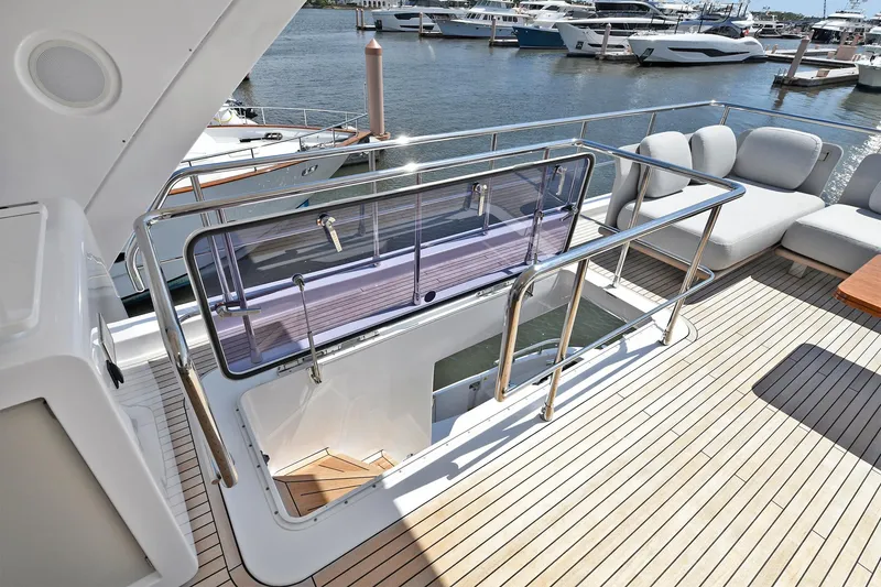 Slide: The Image of Azimut 72 FLY 2022 yacht deck with seating and marina view. - 33