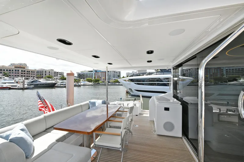 Slide: The Image of Outdoor seating area on the 2022 Azimut 72 FLY yacht, docked at a marina. - 35