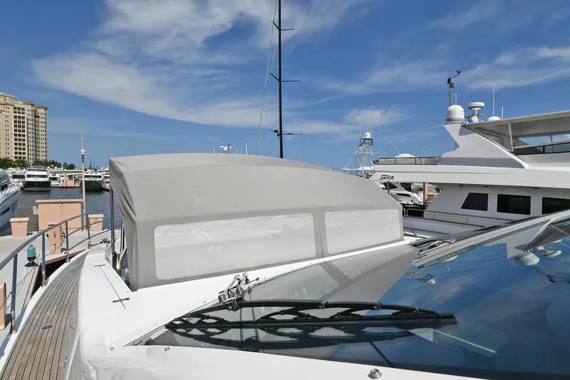 Slide: The Image of 2022 Azimut 72 FLY yacht docked at a marina under a clear blue sky. - 40