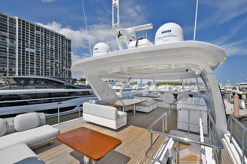 Slide: The Image of Luxury Azimut 72 FLY yacht 2022 model, spacious deck with modern seating, docked at marina. - 44