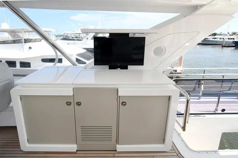 Slide: The Image of Azimut 72 FLY 2022 yacht interior with TV and storage cabinets. - 46