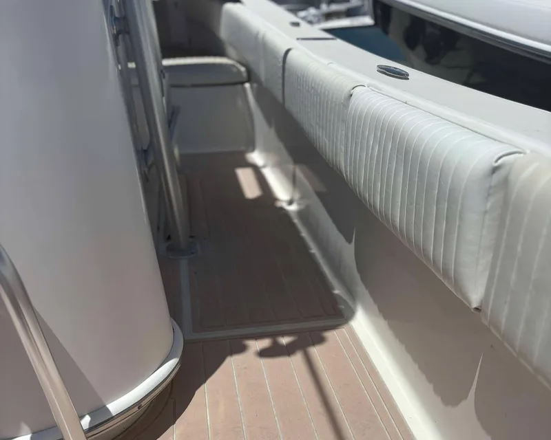 Slide: The Image of 2009 Andros Tarpon 26 boat interior with cushioned seating and sleek design. - 12