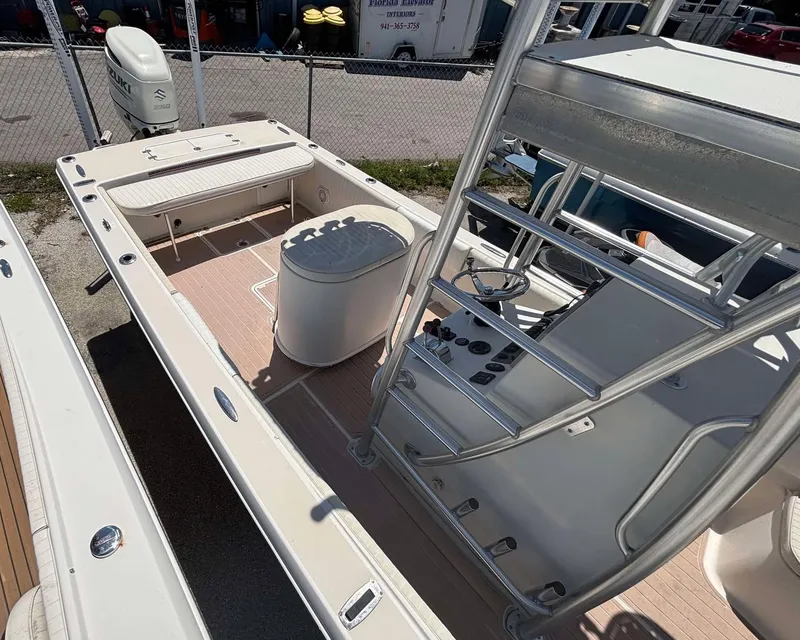 Slide: The Image of 2009 Andros Tarpon 26 boat with center console and seating, docked in a marina. - 15