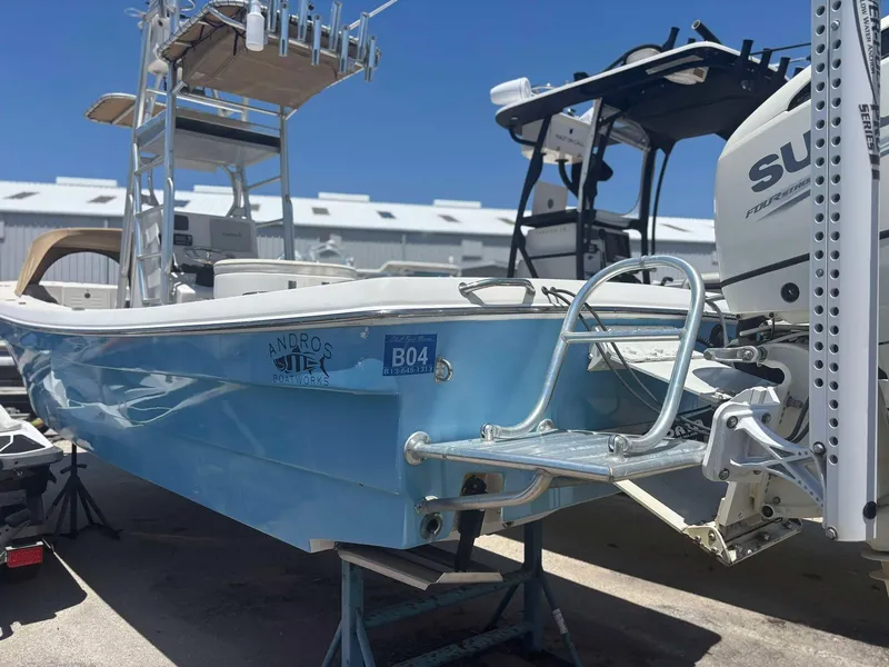 Slide: The Image of 2009 Andros Tarpon 26 boat with outboard motor, docked under clear blue sky. - 18