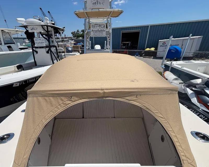 Slide: The Image of 2009 Andros Tarpon 26 boat with beige canopy, docked in a marina. - 5