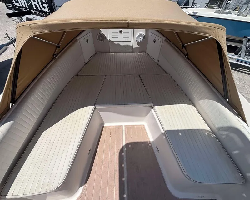 Slide: The Image of 2009 Andros Tarpon 26 boat interior with beige canopy and cushioned seating. - 6